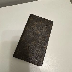 Louis Vuitton check book holder and has slots for credit cards